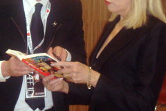 Amanda-Lear-signing-a-book-that-Ronny-brought-which-features-a-photo-of-Amanda
